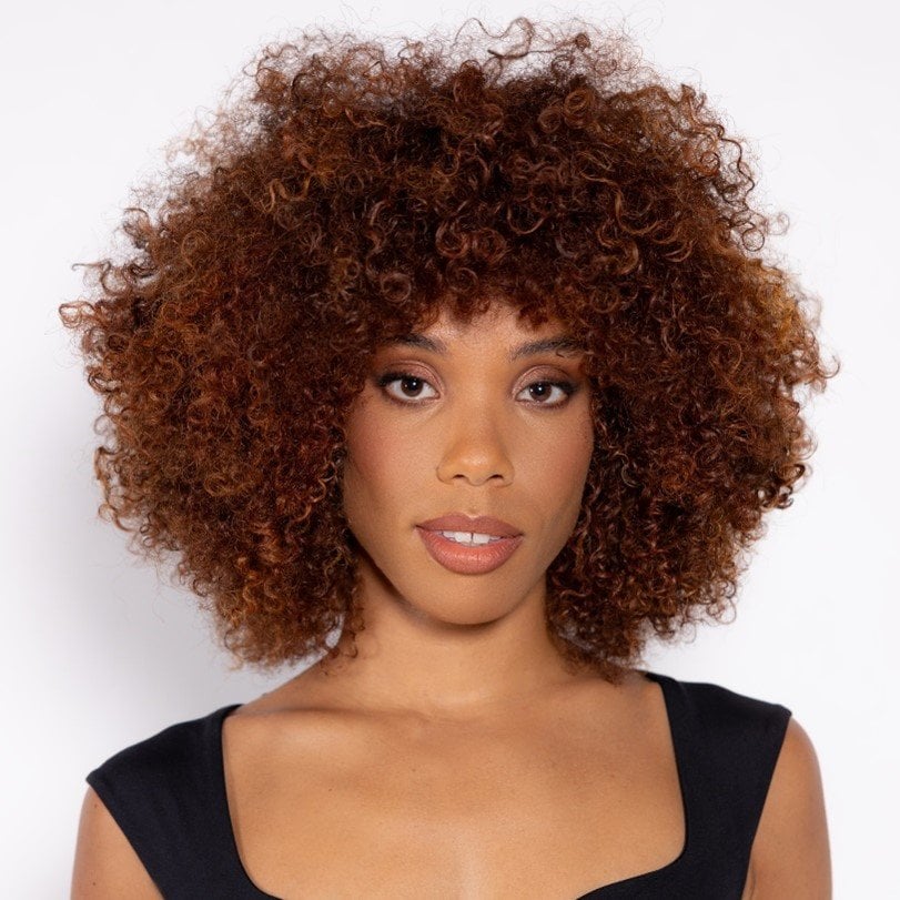 An Instagram reel from L’Oreal Professionnel depicting a hair stylist unveiling a hair colour transformation from dark to cherry cola shade on a woman with brown eyes