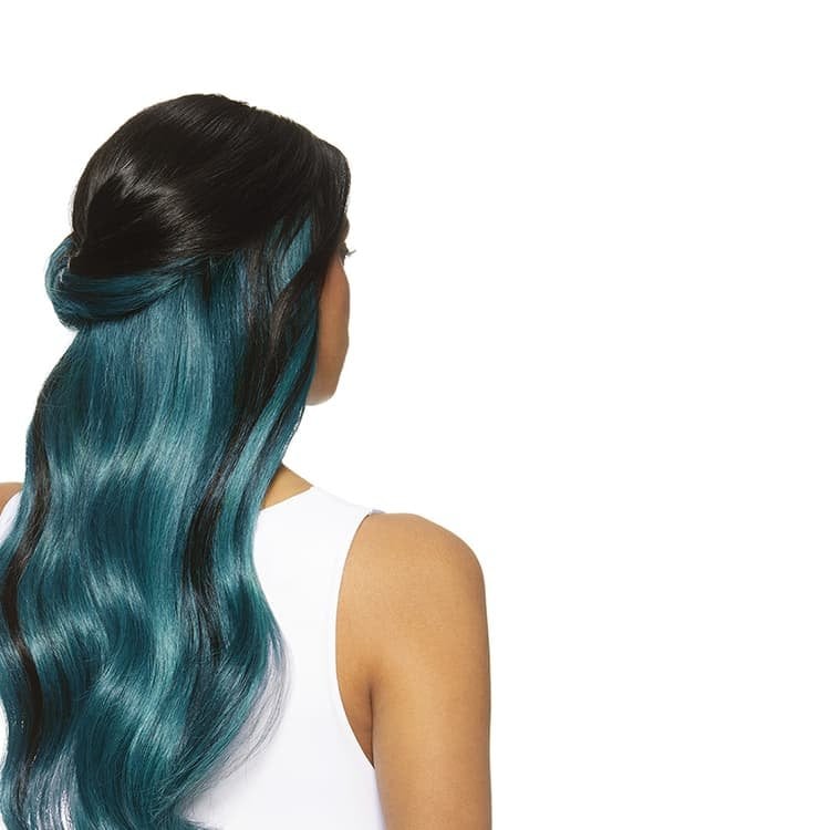 Close-up of a woman’s peekaboo hair color with dark hair on top and hidden turquoise strands underneath for a bold contrast